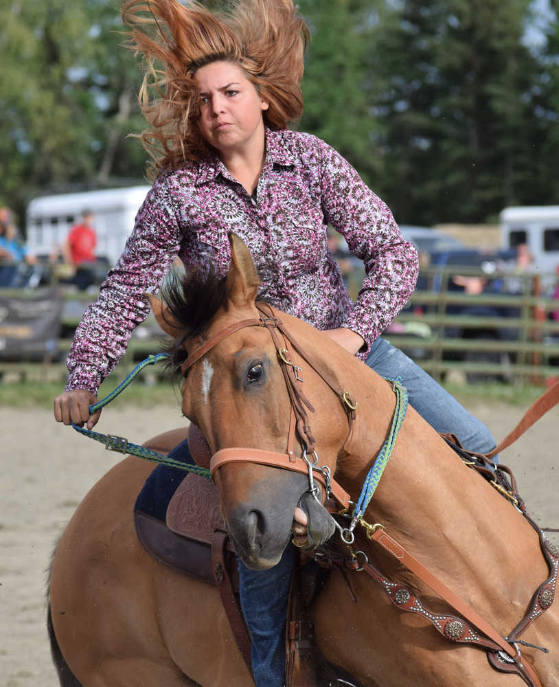 Photo by Joey Klecka/Peninsula Clarion Wasilla rider Andrea Jennings guides her horse through a barrel course June 25 at the Soldotna rodeo grounds.