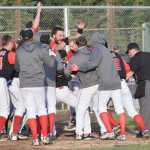 Photo by Jeff Helminiak/Peninsula Clarion Oilers third baseman Jeffrey Chapuran (center, hand on head) is mobbed by teammates after hitting a walk-off home run against the Chugiak Chinooks on Friday at Coral Seymour Memorial Park in Kenai.