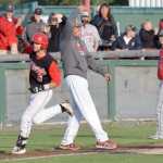 Photo by Jeff Helminiak/Peninsula Clarion Oilers third baseman Jeffrey Chapuran takes a high-five from Oilers head coach Brian Daly after hitting a walk-off home run in the Oilers' 2-1 victory over the Chugiak Chinooks on Friday at Coral Seymour Memorial Park in Kenai.