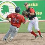 Photo by Jeff Helminiak/Peninsula Clarion Oilers shortstop Trey Dawson helps get his team out of a jam by turning a double play in front of Chinooks third baseman Tim Millard in the eighth inning Friday at Coral Seymour Memorial Park in Kenai.