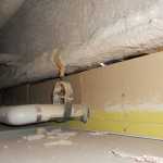 This photo provided by Kenai Peninsula Borough School District Planning and Operations Director Julie Sisco shows asbestos-containing fireproof material coating a beam inside the cieling of the Kenai Middle School.