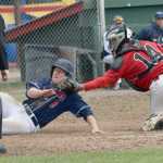 Photo by Jeff Helminiak/Peninsula Clarion Peninsula Oilers catcher Jordan Frese tags out Aaron Shackelford of the Chugiak Chinooks at home plate in the sixth inning Sunday at Coral Seymour Memorial Park in Kenai to keep the score locked at 2-2.