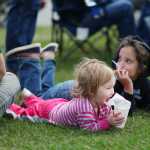 Photo by Kelly Sullivan/ Peninsula Clarion Shelby and Chevelle Gourley snack on snowcones during Kenai's July 4th festivities Monday, July 4, 2016 in Kenai, Alaska.
