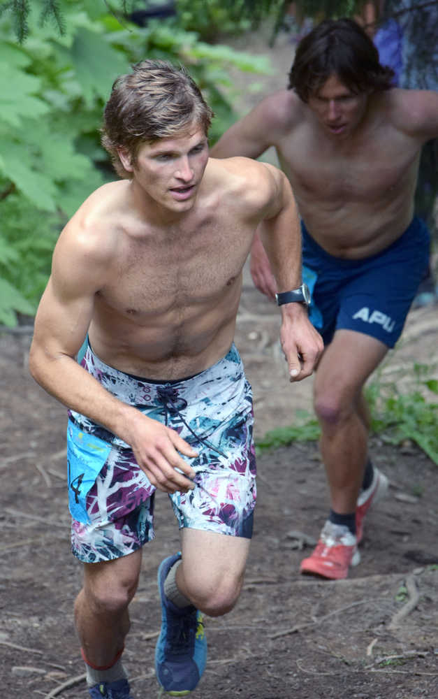 Mount Marathon men's champion David Norris leads Alaska Pacific University ski program teammate Scott Patterson up the lower part of the mountain Monday in Seward.