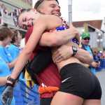 Photo by Jeff Helminiak/Peninsula Clarion Eric Strabel congratulates his wife, Denali Foldager-Strabel, on her third-place finish Monday at the women's Mount Marathon race in Seward.