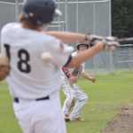 Photo by Joey Klecka/Peninsula Clarion Joey Becher (18) takes a swing at an East Anchorage pitch while Post 20 Twins teammate Paul Steffensen looks on Wednesday afternoon at the Bill Miller Big Fish Wood Bat tournament at the Kenai Little League Fields.