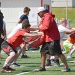 Photo by Jeff Helminiak/Peninsula Clarion Kenai Central's Matthew Zorbas practices blocking with ex-NFL player Tony Casillas at the Alaska All Star Football Camp on Friday at Kenai Central High School. In the background observing the drill is ex-NFL player Flozell Adams.