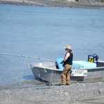 Photo by Elizabeth Earl/Peninsula Clarion A salesman parks his boat on the edge of Kenai River on Monday, July 18, 2016 in Kenai, Alaska. Vendors have focused in on the personal use dipnet fishery in Kenai as a new market to reach.