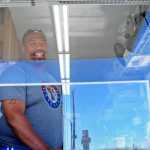 Photo by Elizabeth Earl/Peninsula Clarion Kalani Ross, the owner of Ol' Boy Cuisine, mans his food truck on the north Kenai Beach on Friday, July 15, 2016 in Kenai, Alaska. Ross is among a number of vendors serving the personal use dipnet fishery at the mouth of the Kenai River.