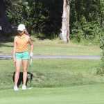 Photo by Jeff Helminiak/Peninsula Clarion Shane Sundberg of Sterling Elementary chips on to the 18th green as Anika Richards looks on Tuesday at the Birch Ridge Jr Masters at Birch Ridge Golf Course in Soldotna.