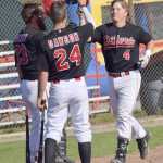Photo by Jeff Helminiak/Peninsula Clarion Jonathan Washam (4) is congratulated on his two-run home run in the bottom of the first inning by Seth DeWitt and Trey Dawson on Thursday at Coral Seymour Memorial Park in Kenai.