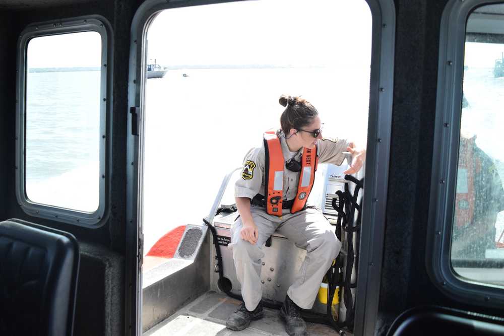 Photo by Megan Pacer/Peninsula Clarion Temporary Enforcement Officer Morgan Wensley talks with Kenai Police Officer Morgan Ezell while on the first no-wake patrol of the dipnet season Tuesday, July 19, 2016 in Kenai, Alaska, on the Kenai Fire Department's patrol boat.