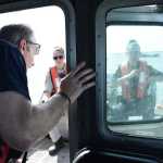 Photo by Megan Pacer/Peninsula Clarion Kenai Fire Battalion Chief Tony Prior checks in with Temporary Enforcement Officer Morgan Wensley and Kenai Police Officer Morgan Ezell during the first no-wake patrol of the personal-use dipnet season Tuesday, July 19, 2016 on the Kenai River. The fire and police departments work together to enforce the no-wake rules during high tides when banks are susceptible to erosion.