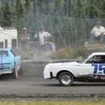 Photo by Joey Klecka/Peninsula Clarion Amy Hermanns spins out of the fourth turn while Artie Niemi (75) slips by Saturday at Twin City Raceway in Kenai.