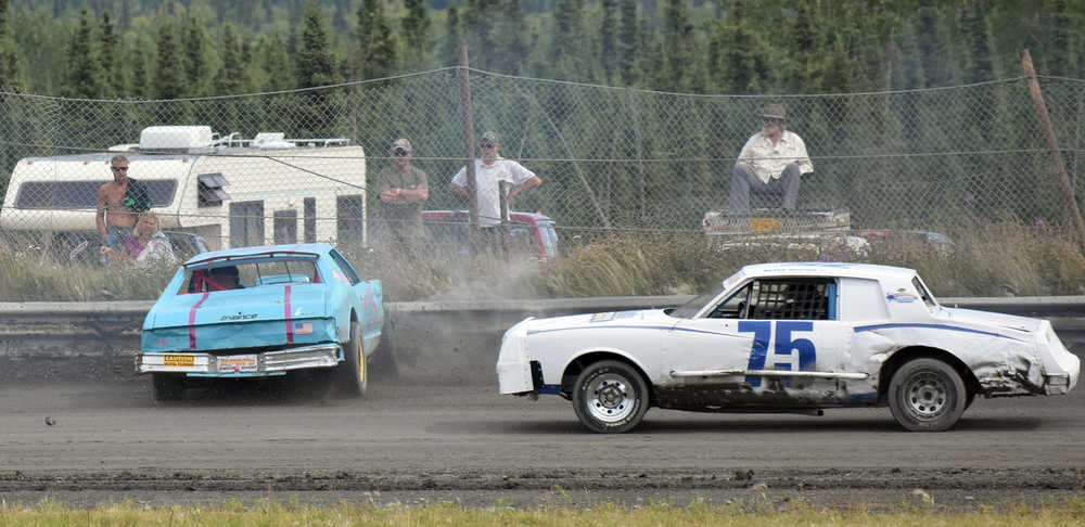Photo by Joey Klecka/Peninsula Clarion Amy Hermanns spins out of the fourth turn while Artie Niemi (75) slips by Saturday at Twin City Raceway in Kenai.