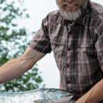 Photo by Elizabeth Earl/Peninsula Clarion Chuck Lindsay displays a salmon on its way to be delivered to a customer on Tuesday, July 26, 2016 in Soldotna, Alaska. Lindsay, one of the owners of Kenai Wild Salmon Co., is a direct seafood marketer, taking part of his catch directly to customers rather than going through a processor.
