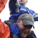 Photo by Kelly Sullivan/ Peninsula Clarion Audience members came well prepared for the rain that muddied the fairgrounds Saturday, Aug. 7, 2016 at Salmonfest 2016 in Ninilchik, Alaska.