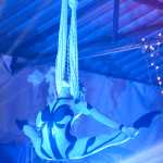 Photo by Megan Pacer/Peninsula Clarion Sammy Sunshyne, an aerialist with Quixotic, swings from a net during the group's performance Sunday, Aug. 7, 2016 at Salmonfest in Ninilchik, Alaska. Quixotic is a cirque nouveau that blends live music with dance, lights and other performance art.