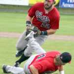 After fielding a bunt, Peninsula second baseman Marshall Boggs tries not to trip over first baseman Jonathan Washam, who slipped to the grass, during a 9-4 Oilers loss to Mat-Su Sundy, Aug. 7, 2016, in the Alaska Baseball League Top of the World Series. The Miners clinched the 2016 ABL title with the win.
