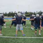 Photo by Joey Klecka/Peninsula Clarion The Soldotna offensive backfield tags hands moments before the snap of a play Wednesday afternoon at Justin Maile Field in Soldotna.