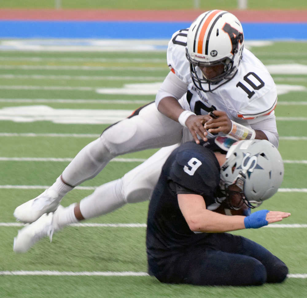 Photo by Jeff Helminiak/Peninsula Clarion West quarterback Qyntyn Pilcher tackles Sodotna cornerback Jace Urban after Urban picked off Pilcher in the fourth quarter of Soldotna's 49-30 victory Friday at Justin Maile Field in Soldotna.