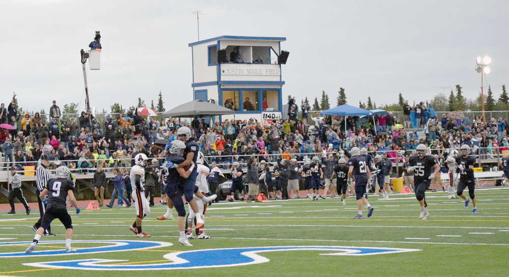 Photo by Jeff Helminiak/Peninsula Clarion Soldotna's Aseli Finau congratulates Andy West after his fourth-quarter touchdown Friday at Justin Maile Field in Soldotna. The Stars won 49-30.