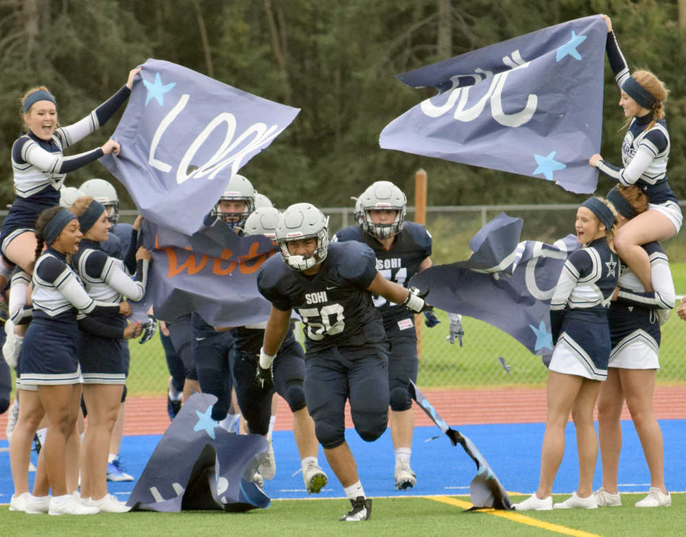 Photo by Jeff Helminiak/Peninsula Clarion Soldotna's Wendell Tuisaula leads Soldotna back onto Justin Maile Field for the second half against West on Friday.