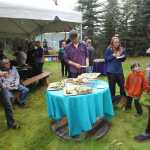 Photo by Kelly Sullivan/ Peninsula Clarion Attendees of the Farm to Table Supper event chow down on menu items made 100 percent from local ingredients by the Willow King , owner of the Where It's At! food bus, and her team of cooks for the  Kenai Local Food Connection's third annual Harvest Moon Festival on Sunday, Aug. 14, 2016, in Soldotna, Alaska.