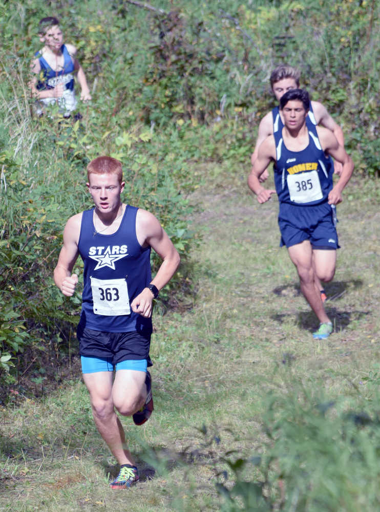 Photo by Jeff Helminiak/Peninsula Clarion Soldotna sophomore Jeremy Kupferschmid leads Homer's Luca Fasulo, Homer's Dexter Lowe and Soldotna's Lance Chilton early in the freshmen-sophomore boys race. Lowe would win the race.