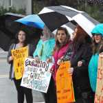 Photo by Elizabeth Earl/Peninsula Clarion Counter-protesters line up and chant "We are the wall, the separation of church and state" near where members of the Catholic Church gathered to pray near the Kenai Peninsula Borough Administration Building on Wednesday, Aug. 17, 2016 in Soldotna, Alaska. The church members decided to pray outside the borough administration building after a Satanic invocation was given to open the borough assembly meeting Aug. 9.