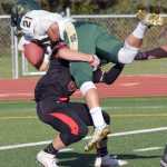 Photo by Jeff Helminiak/Peninsula Clarion Service's Jacob Wade recovers from getting lifted in the air by Kenai's Rykker Riddall to score a touchdown Friday and Ed Hollier Field in Kenai.