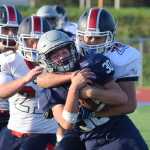 Photo by Joey Klecka/Peninsula Clarion Soldotna sophomore Hunter Woodward tries to shed North Pole tackler C.J. Fontana in the second half of Friday evening's game at Justin Maile Field in Soldotna.