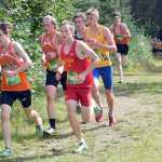 Photo by Jeff Helminiak/Peninsula Clarion West's Finn Walker pulls the lead pack away from the field about halfway through the Tsalteshi Invitational at Tsalteshi Trails on Saturday.