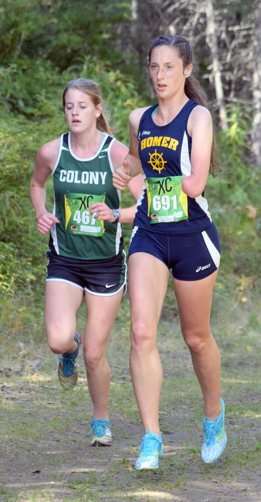 Photo by Jeff Helminiak/Peninsula Clarion Homer's Megan Pitzman leads Colony's Jill Bowker a little over two kilometers into the Tsalteshi Invitational at Tsalteshi Trails on Saturday.
