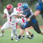 Thunder Mountain's Duane Harwell, right,  puts pressure on Kenai's quarterback Chase Gillies at TMHS on Friday. Kenai won the game 23-12.