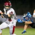 Kenai's Rykker Riddall breaks a tackle attempt by Thunder Mountain's Jaspa Palffy at TMHS on Friday. Kenai won the game 23-12.