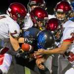 Thunder Mountain's Hansel Hinckle is taken down by Kenai's defensive line at TMHS on Friday. Kenai won the game 23-12.