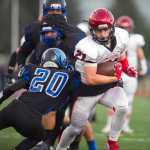 Kenai's Zack Tuttle, right, breaks a tackle by Thunder Mountain's Jacab Tapia at TMHS on Friday. Kenai won the game 23-12.