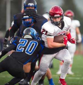 Kenai's Zack Tuttle, right, breaks a tackle by Thunder Mountain's Jacab Tapia at TMHS on Friday. Kenai won the game 23-12.