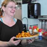 Samantha Nushart, an employee at Double O Express, holds a complete order at the restaurant on Tuesday, Aug. 23, 2016 in Kenai, Alaska. The restaurant recently moved from its old location next to the Bow Bar in Old Town Kenai to a brick-and-mortar location in the Kenai Airport that used to house Odie's Deli.