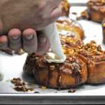 Dave Olson of Double O Express ices a sticky bun at the restaurant on Tuesday, Aug. 23, 2016 at the Kenai Airport in Kenai, Alaska. Olson, who owns the restaurant with his wife Tammy, formerly worked as a chef on the North Slope before opening the restaurant in April 2015.