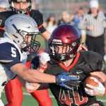 Photo by Jeff Helminiak/Peninsula Clarion Kenai Central's Jonathan Hawkins corrals Eagle River quarterback Thad Heagy for a sack Friday at Ed Hollier Field in Kenai.
