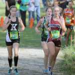 Kenai Central's Jaycie Calvert runs alongside athletes from Dimond and Colony during the 4A girls' race of the Palmer Invitational Saturday, Sept. 3, 2016, in Palmer. Calvert finished 10th in the race.