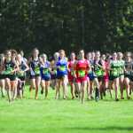 A pack of runners leaves the start at the beginning of the 4A girls' race during the Palmer Invitational Saturday, Sept. 3, 2016, at Palmer High School. More than 1,000 athletes competed in the meet, which included junior varsity and varsity races in both the small and large-schools classes. For more, see frontiersman.com/sports and the Wednesday edition of the Frontiersman.