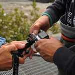Photo by Elizabeth Earl/Peninsula Clarion Cook Inlet Aquaculture Association Executive Director Gary Fandrei (left) and biologist Rodney Hobby (right) adjust a GoPro camera to film a possible leak beneath the Paint River fish ladder Friday, Sept. 2, 2016 on the Paint River near the McNeil River State Game Sanctuary and Refuge, Alaska. Cook Inlet Aquaculture Association operates the fish ladder to allow salmon to pass into the upper reaches of the remote river system to spawn.