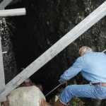 Photo by Elizabeth Earl/Peninsula Clarion Cook Inlet Aquaculture Association Executive Director Gary Fandrei points a GoPro camera on a pole beneath the organization's Paint River fish ladder to get a picture of a potential leak Friday, Sept. 2, 2016 near the McNeil River State Game Sanctuary and Refuge, Alaska. Cook Inlet Aquaculture Association operates the fish ladder to allow salmon to pass into the upper reaches of the remote river system to spawn.