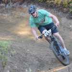 Photo by Jeff Helminiak/Peninsula Clarion Eric Willets swings around a corner on the new singletrack Saturday at Tsalteshi Trails duing Psychocross.