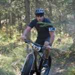Photo by Jeff Helminiak/Peninsula Clarion Eric Thomason corners through the Mosquite singletrack Saturday at Tsalteshi Trails during Psychocross.