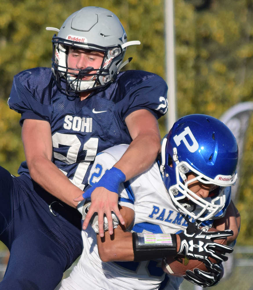 By Joey Klecka/Peninsula Clarion Palmer defensive back Jared Oviok intercepts a pass meant for Soldotna's Levi Hensley (21) early in Friday evening's Northern Lights Conference game at Justin Maile Field in Soldotna.
