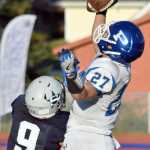 By Joey Klecka/Peninsula Clarion Palmer receiver Larry Cutsforth corrals a pass over Soldotna's Jace Urban (9) Friday evening at Justin Maile Field in Soldotna.